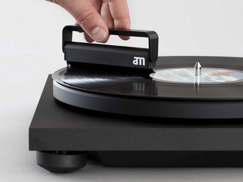 Cleaning a vinyl record with a special brush