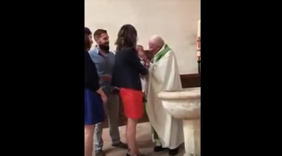 Watch this priest angrily slap a crying baby across the face during a baptism